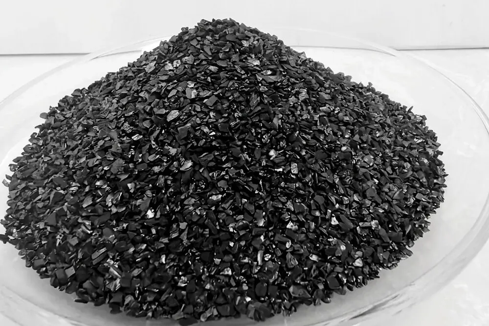 Granular activated carbon, mesh 6x12, heaped in a laboratory dish